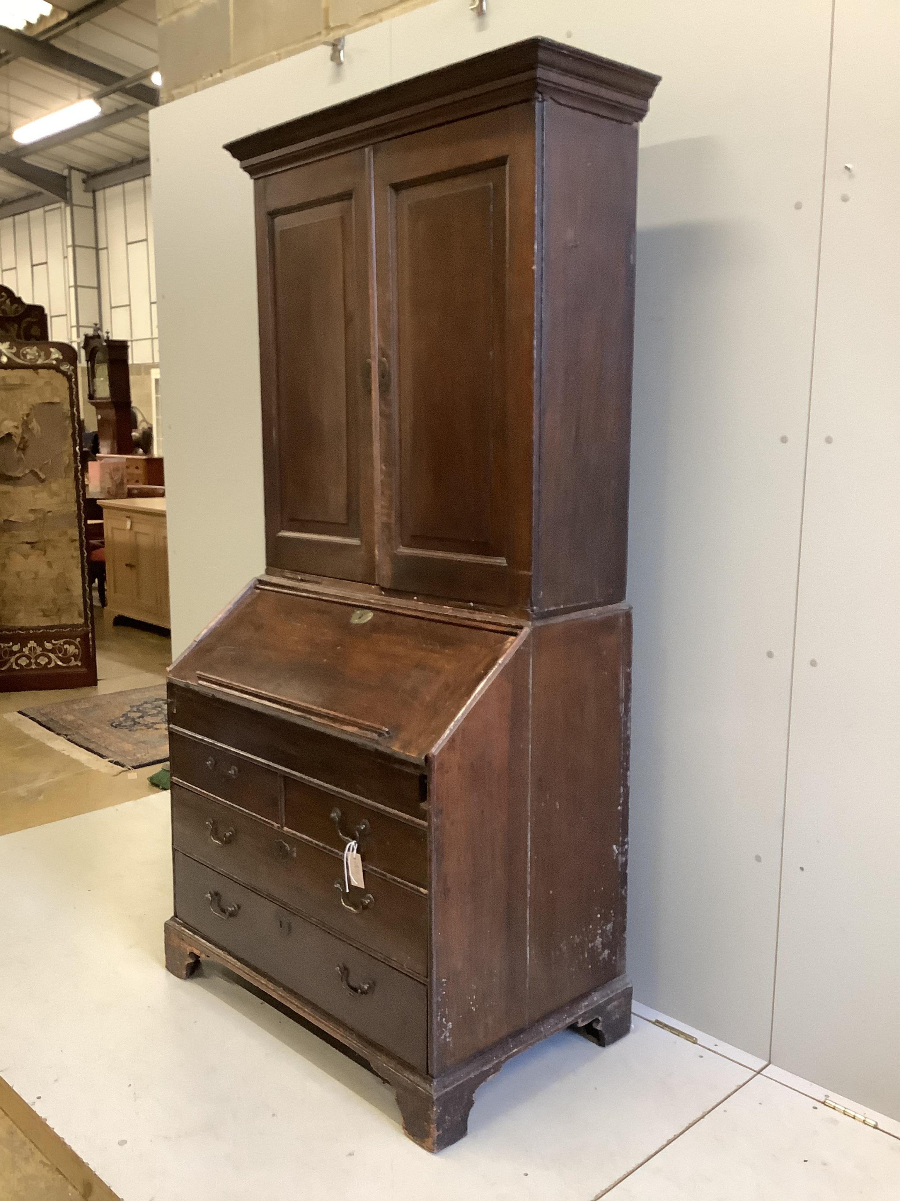 A George III oak bureau cabinet, width 96cm, depth 59cm, height 201cm